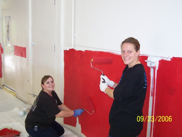 Holly and Sam painting the bays